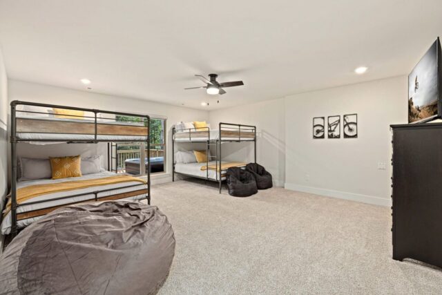 Comfortable bedroom with bunk beds and bean bag chair at OZ Adventure Retreat near Back 40 Trails.