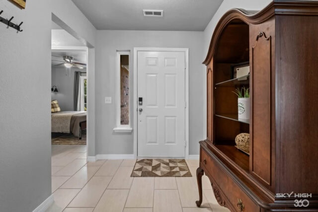 Cozy entryway with wooden furniture and tiled flooring at Biker’s Basecamp and Ozark Retreat near Be.