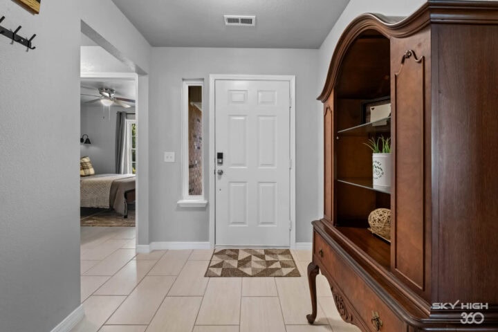 Cozy entryway with wooden furniture and tiled flooring at Biker’s Basecamp and Ozark Retreat near Be.