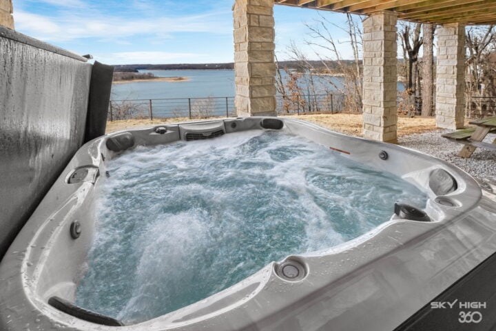 Hot tub overlooking Beaver Lake in Rogers, AR, perfect for relaxing vacations.