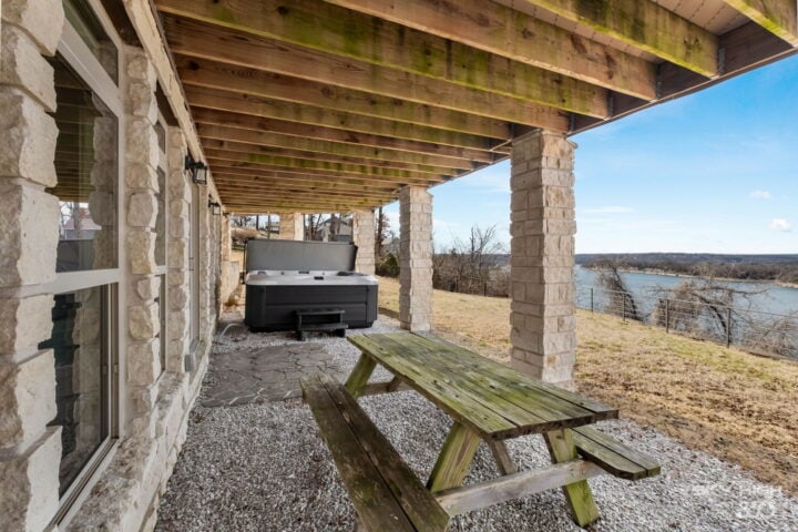 Outdoor patio with lake view and picnic table in Rogers, AR.