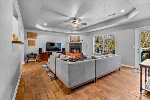 Spacious living room with comfortable seating, fireplace, and large windows in Bella Vista near Back.